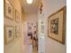 Inviting hallway featuring neutral tones, decorative art, and a view into a brightly lit bedroom at 1416 Lexington Ave, Davenport, FL 33837