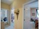Hallway with decorative floral accent leading to carpeted bedrooms and tiled hallways, brightened by natural light at 1416 Lexington Ave, Davenport, FL 33837