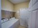 Functional laundry room with washer, dryer, and shelving for added storage and organization at 1416 Lexington Ave, Davenport, FL 33837