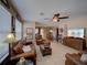 Inviting living room with tile flooring, leather furniture, and a ceiling fan at 1416 Lexington Ave, Davenport, FL 33837