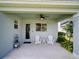 Covered patio offers a cozy space for outdoor seating and relaxation with tranquil backyard views at 1416 Lexington Ave, Davenport, FL 33837