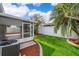 Backyard featuring a lush lawn, privacy fence, and screened patio at 153 Pine Isle Dr, Sanford, FL 32773