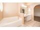 Bathroom featuring garden tub, neutral walls, and tile flooring at 153 Pine Isle Dr, Sanford, FL 32773
