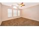 Bright bedroom featuring three windows providing natural light and a ceiling fan at 153 Pine Isle Dr, Sanford, FL 32773