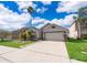 Charming single-Gathering home showcasing mature landscaping and a two-car garage at 153 Pine Isle Dr, Sanford, FL 32773