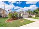 Well-manicured front yard with green grass and attractive, tropical landscaping at 153 Pine Isle Dr, Sanford, FL 32773