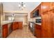 Well-equipped kitchen with cherry cabinets, stainless appliances, and granite countertops at 153 Pine Isle Dr, Sanford, FL 32773