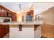 Inviting kitchen featuring granite counters, wood cabinets, and stainless steel appliances at 153 Pine Isle Dr, Sanford, FL 32773
