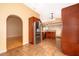 Kitchen featuring tile floors, stainless steel refrigerator, and cherry cabinets at 153 Pine Isle Dr, Sanford, FL 32773