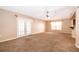 Cozy living room features neutral carpet and French doors to rear patio at 153 Pine Isle Dr, Sanford, FL 32773