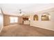 Open living room with ceiling fan, carpet, and arched architectural design to adjoining room at 153 Pine Isle Dr, Sanford, FL 32773
