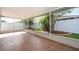 Screened-in lanai with tile flooring, providing a tranquil outdoor space with lush landscaping at 153 Pine Isle Dr, Sanford, FL 32773