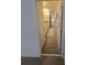 Hallway view of a bathroom showcasing a granite countertop vanity and ceramic tile flooring at 16043 Scarpetta St, Winter Garden, FL 34787