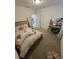 Comfortable bedroom featuring a bed, desk, and large mirror, perfect for study and relaxation at 16043 Scarpetta St, Winter Garden, FL 34787