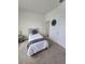 Cozy bedroom featuring a bed, side table, and minimalist decor at 16043 Scarpetta St, Winter Garden, FL 34787