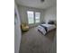Bright bedroom with carpeted floor, a full sized bed and windows at 16043 Scarpetta St, Winter Garden, FL 34787