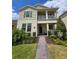 Charming two-story home with a cozy front porch and a well-maintained landscaped yard at 16043 Scarpetta St, Winter Garden, FL 34787