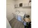 Bright laundry room features washer, dryer, and shelving for storage at 16043 Scarpetta St, Winter Garden, FL 34787