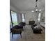 Bright living room with a chandelier, plush seating, and sliding glass doors at 16043 Scarpetta St, Winter Garden, FL 34787