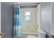 Bathroom with a tub/shower combination and a blue and white shower curtain at 2005 Pitch Way, Kissimmee, FL 34746