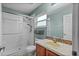 Bright bathroom with white tiled shower, window, and modern fixtures at 2005 Pitch Way, Kissimmee, FL 34746