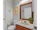 Clean, functional bathroom featuring a toilet, sink, and framed mirror at 2005 Pitch Way, Kissimmee, FL 34746