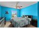 Bright blue bedroom featuring a window, ceiling fan, and comfortable bed at 2005 Pitch Way, Kissimmee, FL 34746