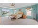Bright bedroom featuring pale-blue walls, neutral carpet, a ceiling fan, and large windows at 2005 Pitch Way, Kissimmee, FL 34746