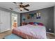 Bedroom with a ceiling fan, accent wall art and bathroom view at 2005 Pitch Way, Kissimmee, FL 34746