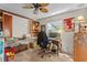 Bedroom/office featuring a ceiling fan, built-in shelving, and a wall with fun, colorful art at 2005 Pitch Way, Kissimmee, FL 34746