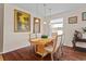 Bright dining room featuring hardwood floors, modern lighting, and a view of the backyard at 2005 Pitch Way, Kissimmee, FL 34746