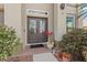 Elegant double front doors with leaded glass and decorative plants enhance the home's curb appeal at 2005 Pitch Way, Kissimmee, FL 34746