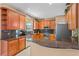 Well-equipped kitchen with granite countertops, stainless steel appliances, and wood cabinets at 2005 Pitch Way, Kissimmee, FL 34746