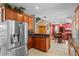 Open kitchen layout with stainless fridge and access to other living areas at 2005 Pitch Way, Kissimmee, FL 34746