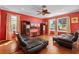 Inviting living room featuring dark leather sofas, wood flooring, and abundant natural light at 2005 Pitch Way, Kissimmee, FL 34746