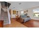 Cozy living space with hardwood and tiled floors, open to dining and stairwell at 2005 Pitch Way, Kissimmee, FL 34746