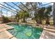 Screened-in pool area with lush tropical landscaping, a spa, and comfortable seating at 2005 Pitch Way, Kissimmee, FL 34746