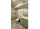 Bathroom featuring a shower, grey vanity, and pebble-lined shower base at 2350 Valley Dr, Apopka, FL 32703