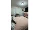 Bedroom with bed and coordinating storage shelves with a view into another room at 2350 Valley Dr, Apopka, FL 32703