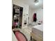 Bright bedroom features a closet, mirror, and stylish furnishings at 2350 Valley Dr, Apopka, FL 32703