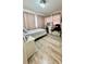 Bedroom with laminate flooring, desk with vanity and teddy bear accent pillow at 2350 Valley Dr, Apopka, FL 32703