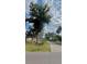 Charming single-story home with lush landscaping, mature trees, and a long driveway at 2350 Valley Dr, Apopka, FL 32703