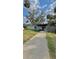 Charming single-story home with a covered front porch, mature landscaping, and a storage shed at 2350 Valley Dr, Apopka, FL 32703