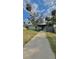 Charming single-story home with a covered front porch and mature landscaping under a bright blue sky at 2350 Valley Dr, Apopka, FL 32703