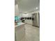Modern kitchen featuring stainless steel appliances, bright white cabinetry, and tile floors at 2350 Valley Dr, Apopka, FL 32703