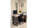 Office area includes desk, shelving for storage and decorative wall hanging at 2350 Valley Dr, Apopka, FL 32703