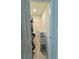 Narrow walk-in closet featuring clothing rack and storage for multiple pairs of shoes at 2350 Valley Dr, Apopka, FL 32703