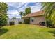 A spacious grassy yard features mature plantings, perfect for outdoor enjoyment and relaxation at 239 King George Dr, Davenport, FL 33837