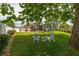 Scenic backyard with Adirondack chairs, a shed, screened enclosure, and lush lawn, perfect for outdoor enjoyment at 239 King George Dr, Davenport, FL 33837