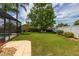 Lush backyard featuring a screen enclosed pool and lots of green space at 239 King George Dr, Davenport, FL 33837
